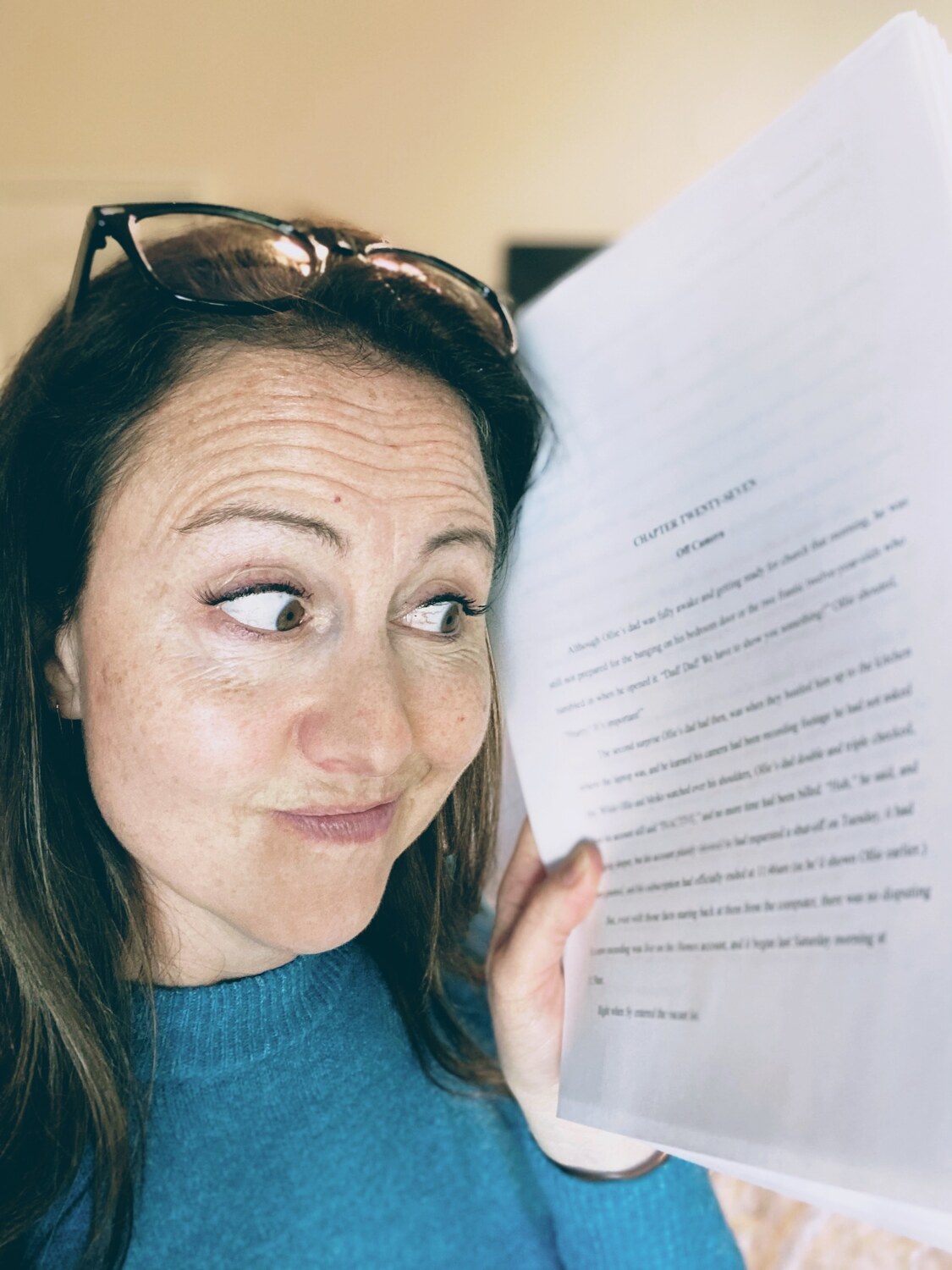 Andi Kate holding a manuscript