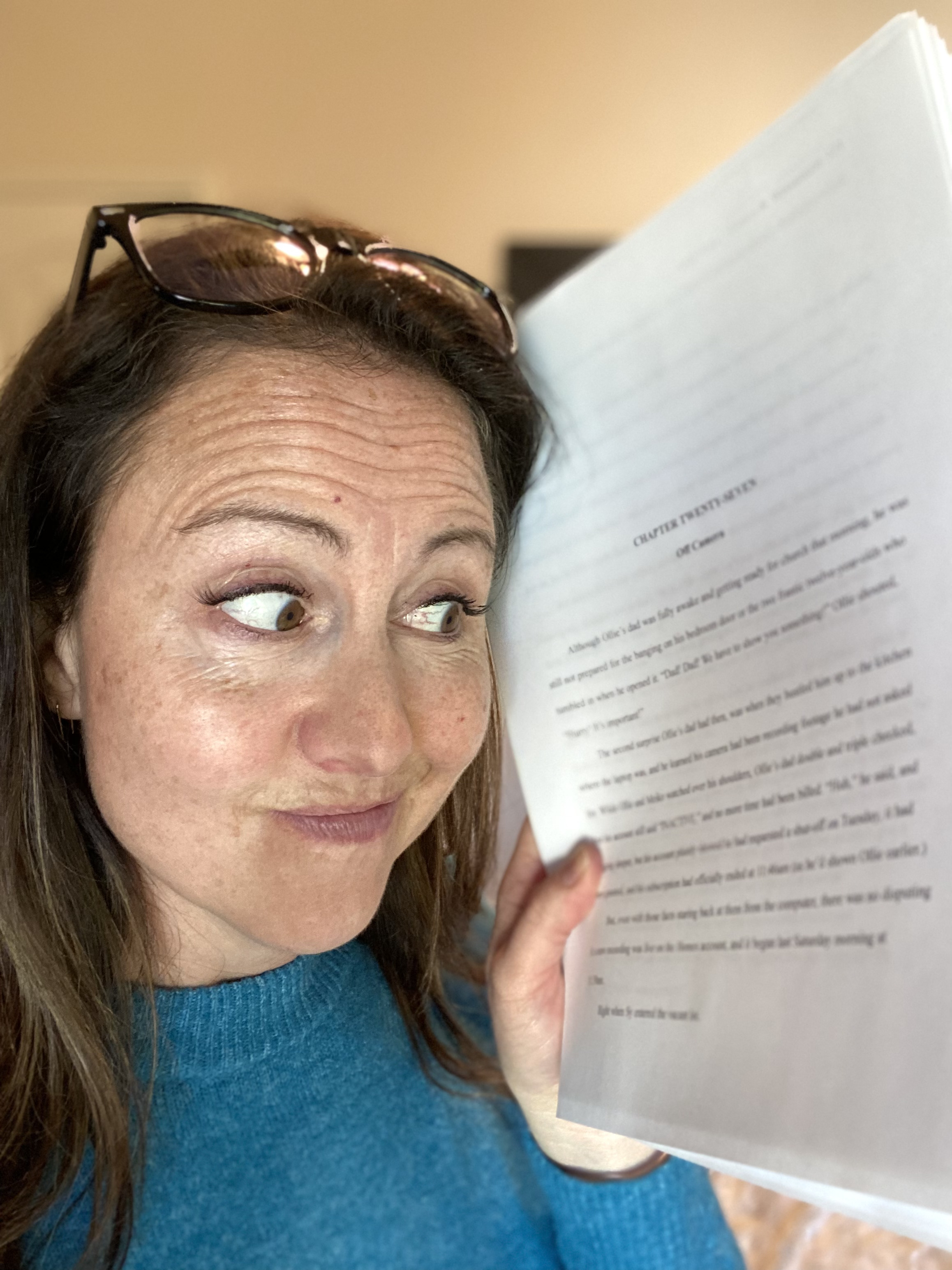 Andi Kate holding a manuscript